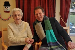 Dean Mann thanks Florence Ringland for the lovely scarf she knit him for his Black Santa sit-out.